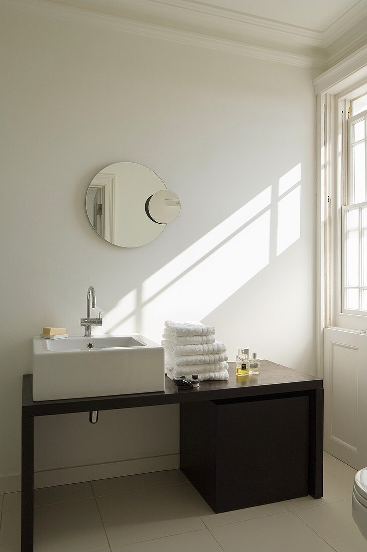 A designer washstand with a mirror in the bathroom of a country house