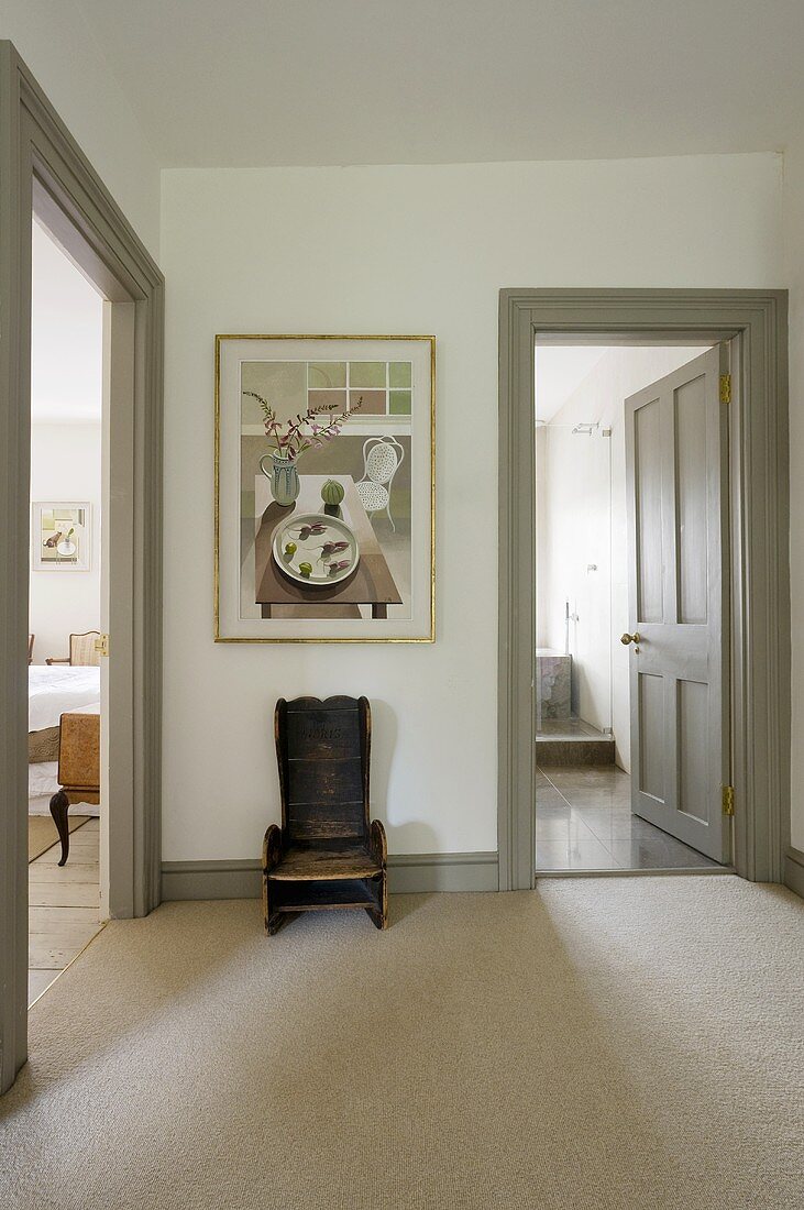 Vorraum mit rustikalem Holzstuhl und Blick auf offene Zimmertüren