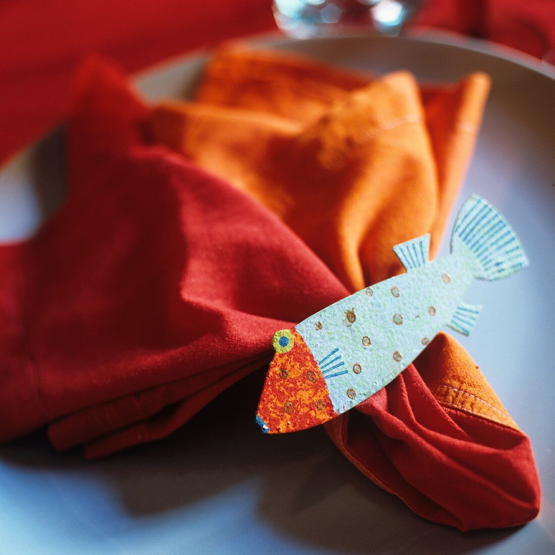 Plate decoration - a fish on an orange napkin
