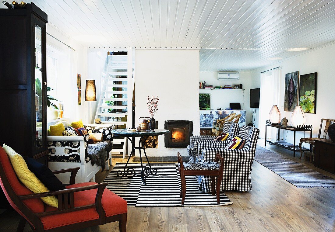 A maisonette apartment - a black and white sofa, a table and a wooden ceiling