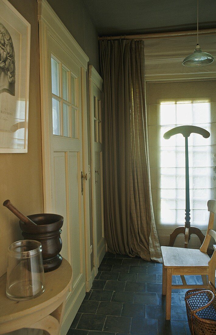 A country house - a curtain and a free-standing coat stand in front of the front door
