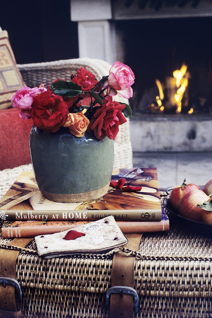 Roses in a ceramic pot on a rattan chest