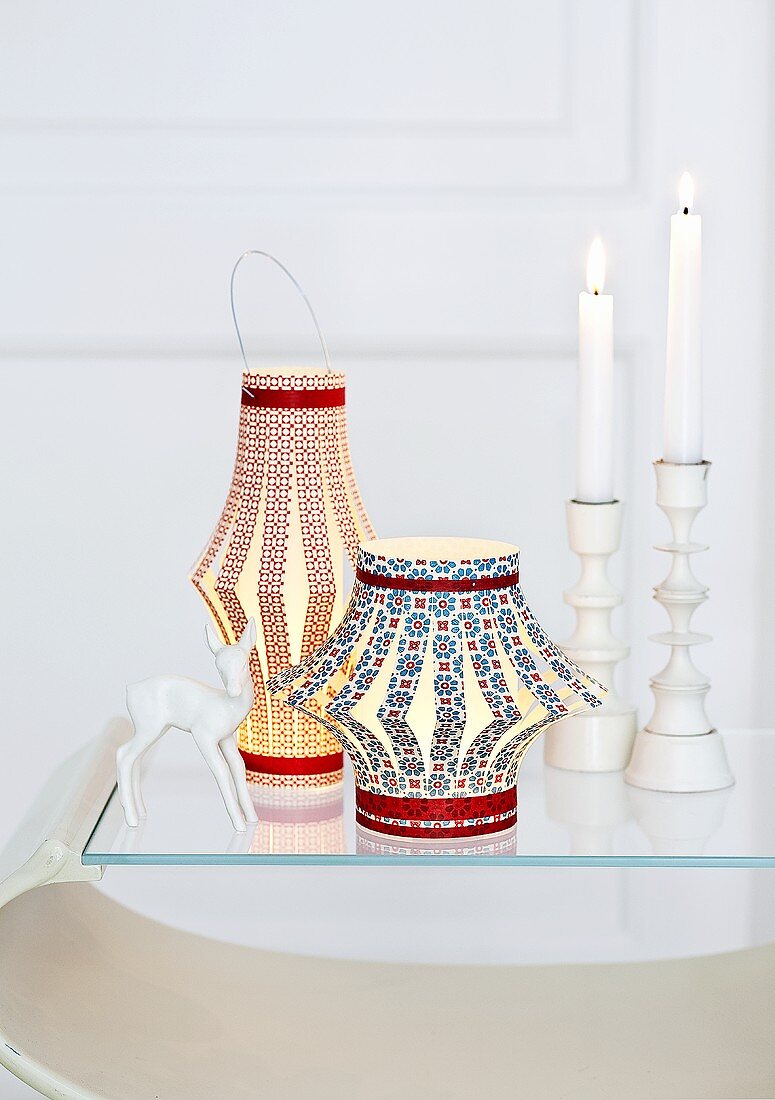 Chinese lanterns and candlesticks with burning candles