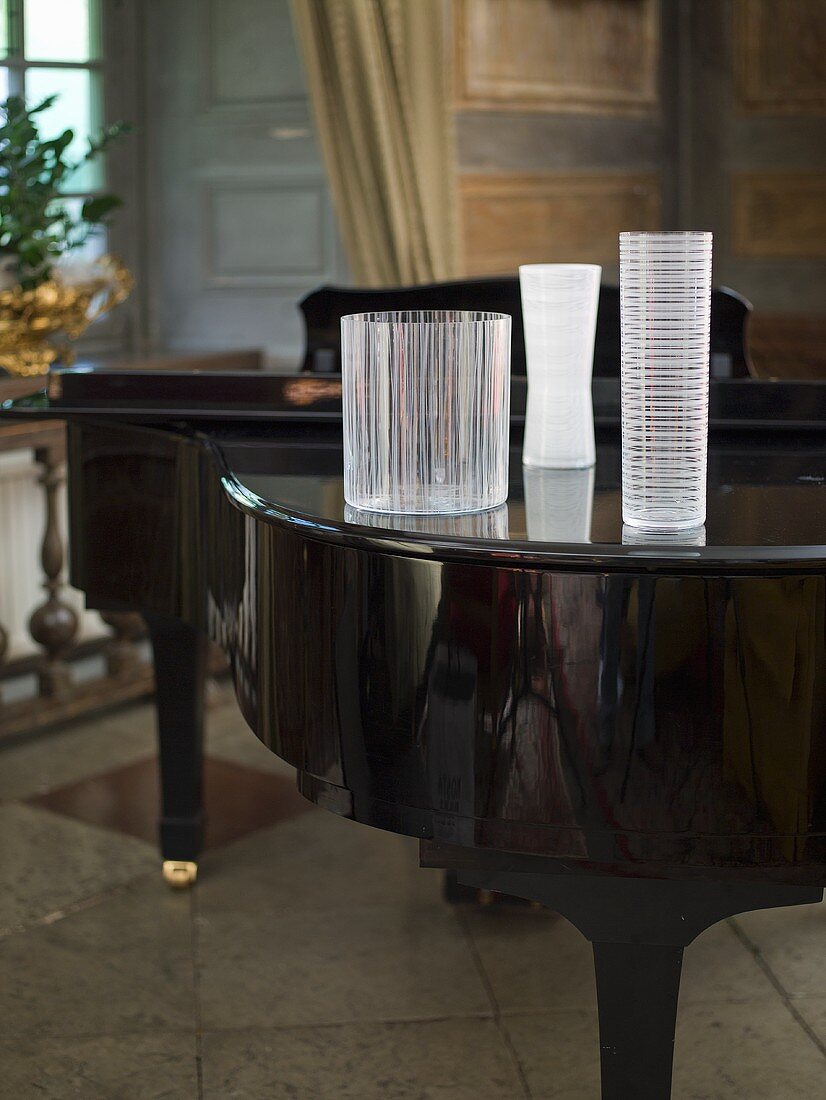 Vases of various shapes on a grand piano