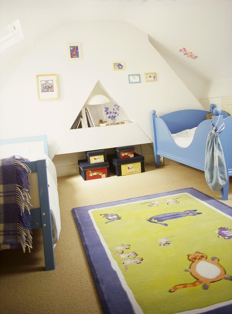 Children's white bedroom with painted beds, toy storage boxes, fun rug