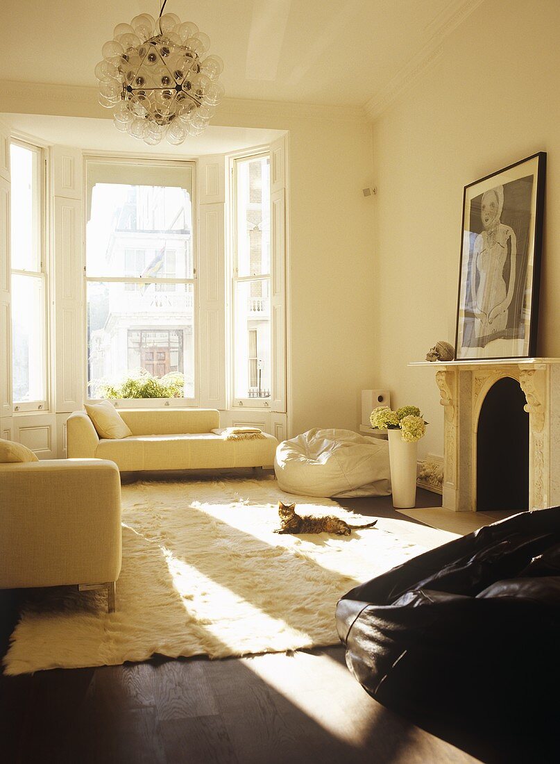 Light, sitting room with neutral furnishings and large windows