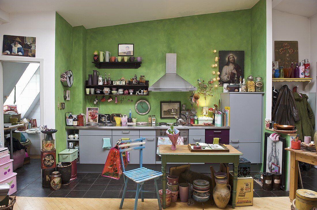 Modern green kitchen with grey units with breakfast table