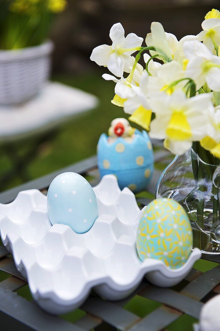 Decorated eggs in a ceramic egg tray