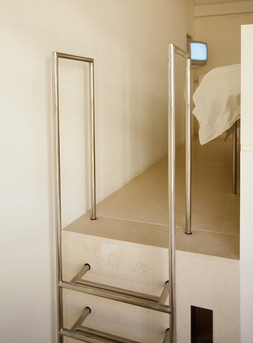 Stainless steel ladder leading up to bedroom