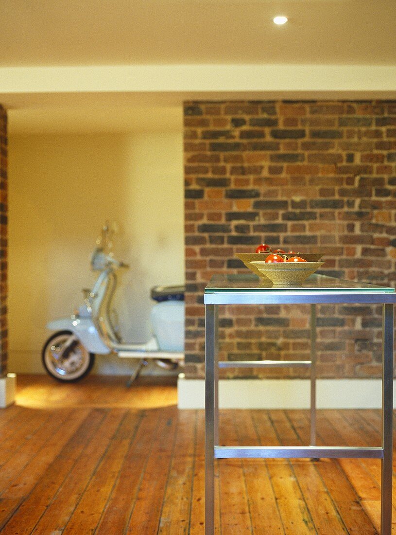 Metal table with glass top with scooter in background