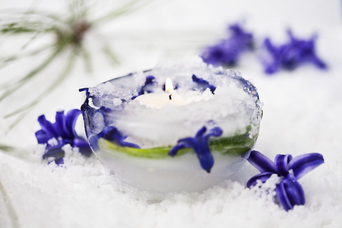 An ice tealight holder decorated with hyacinth flowers