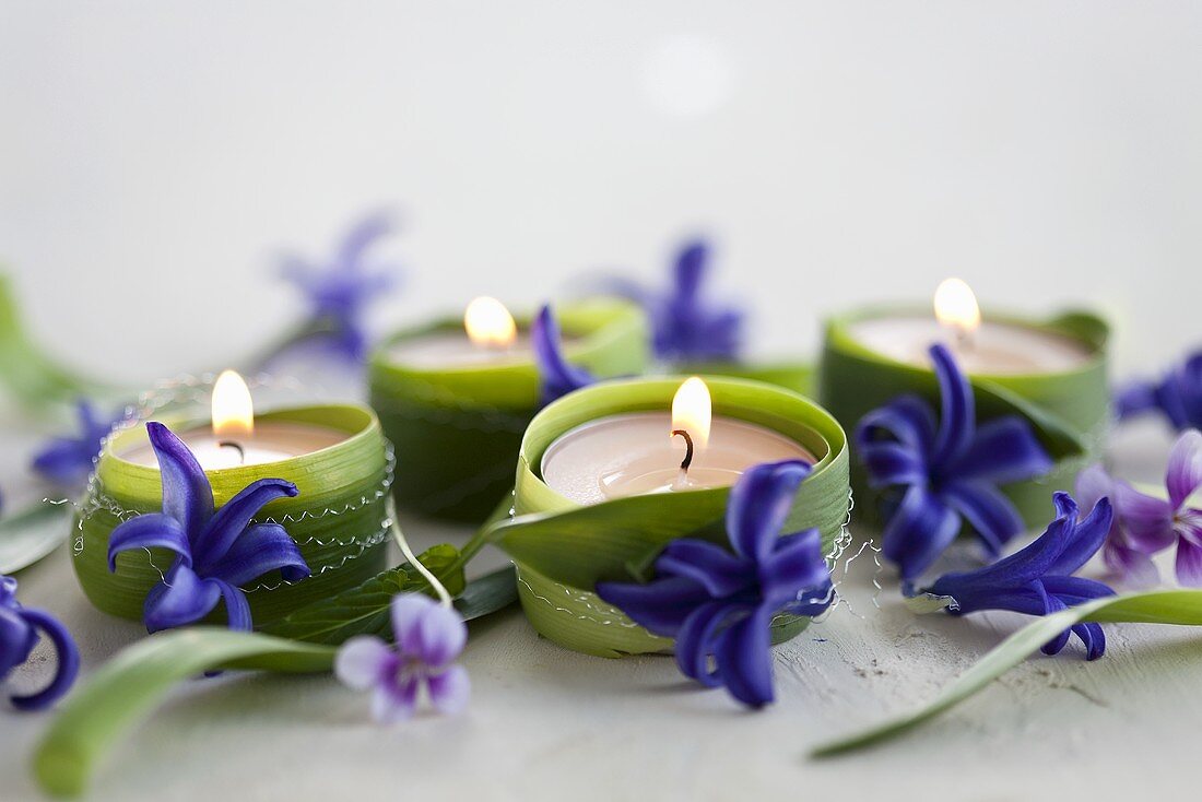 Tea lights wrapped in leaves and decorated with hyacinth flowers