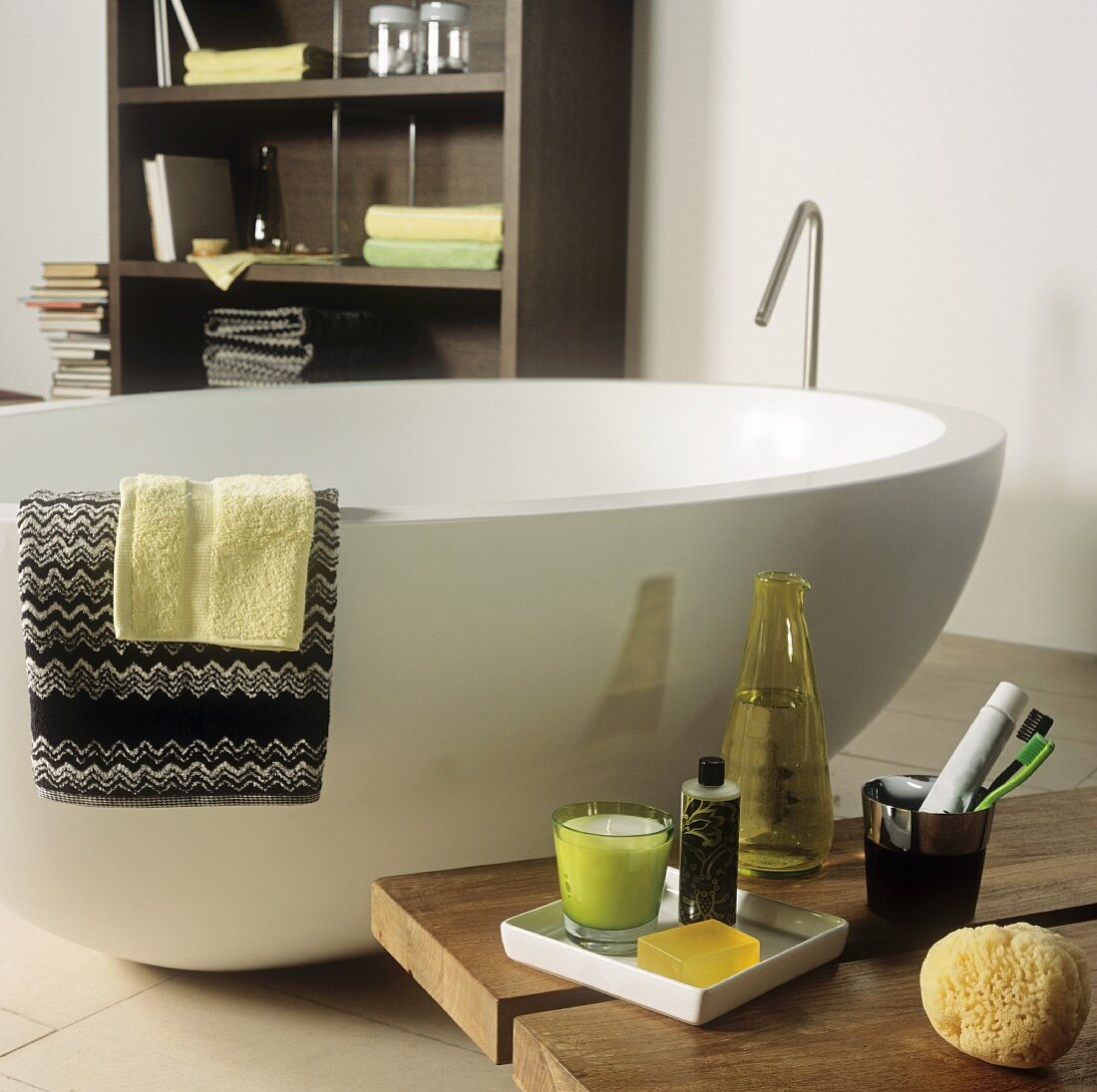 An oval shaped free standing bathtub and bath accessories