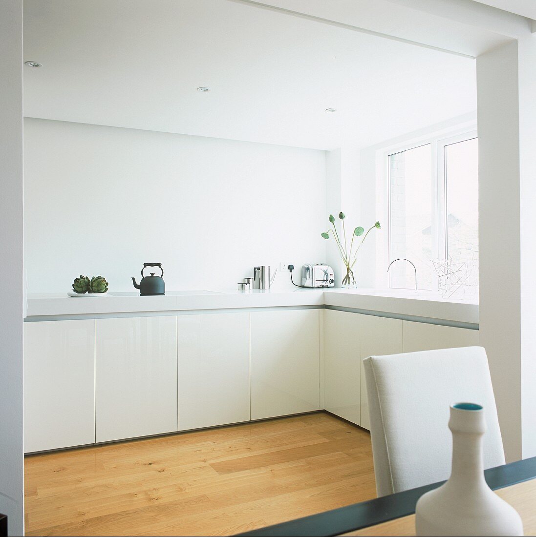 View of an L-shaped white kitchen