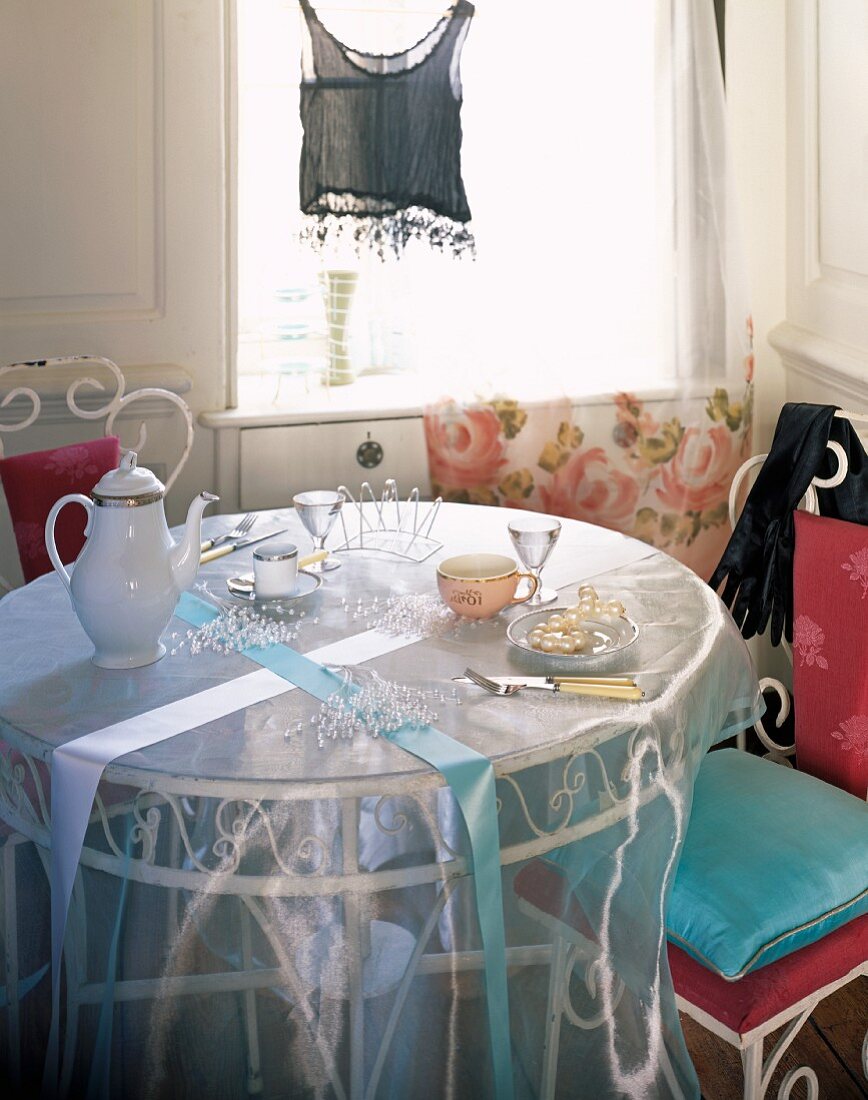 A round coffee table with an elegant tablecloth