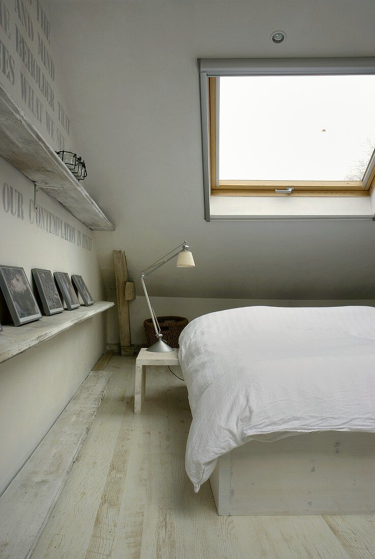 Bedroom under a ceiling with a skylight