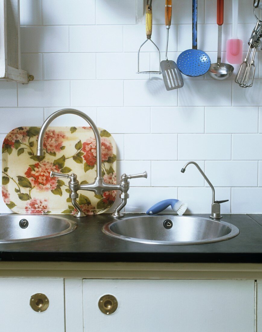 A work surface with two sinks and antique taps