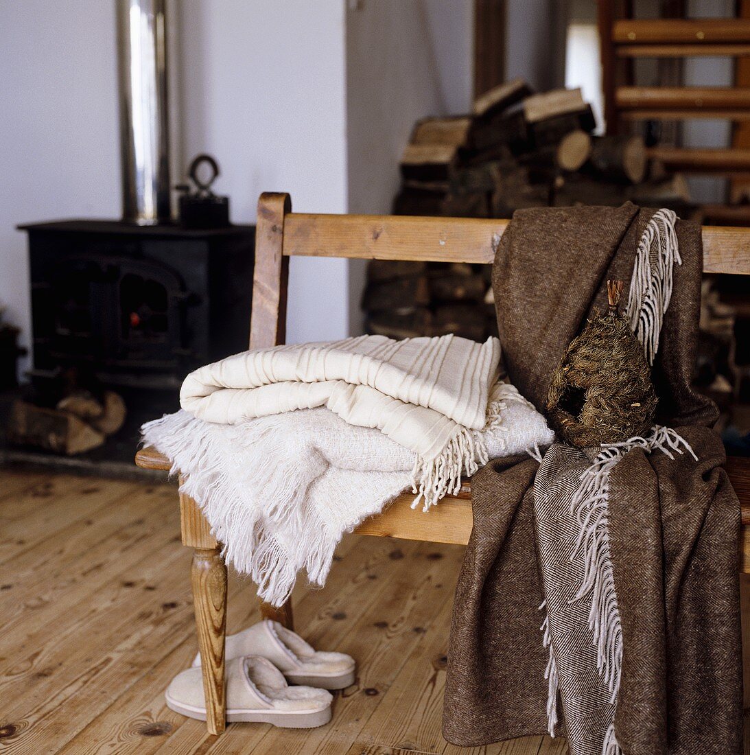Wooden bench with blankets in a country house