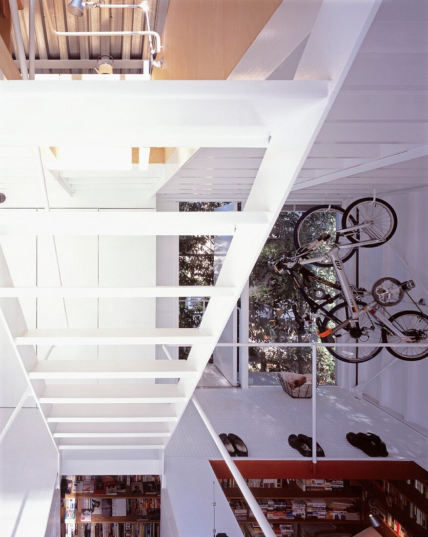 A newly built house with an open stairway and a view into various rooms