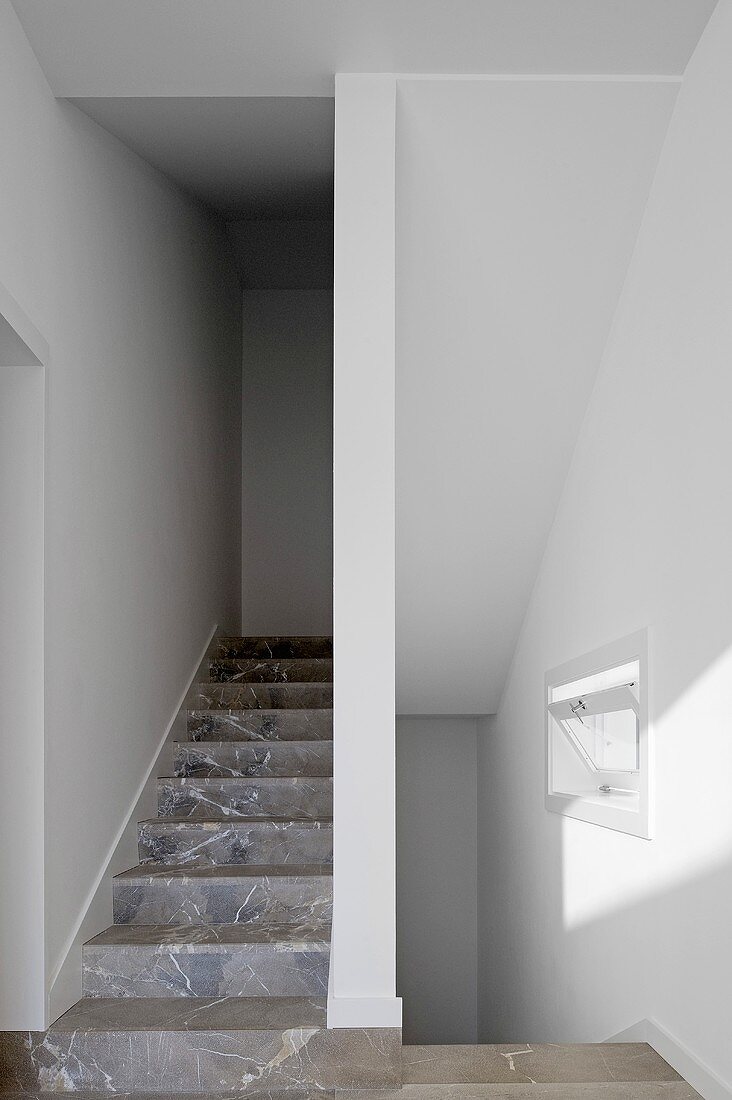 A narrow staircase with marble stairs