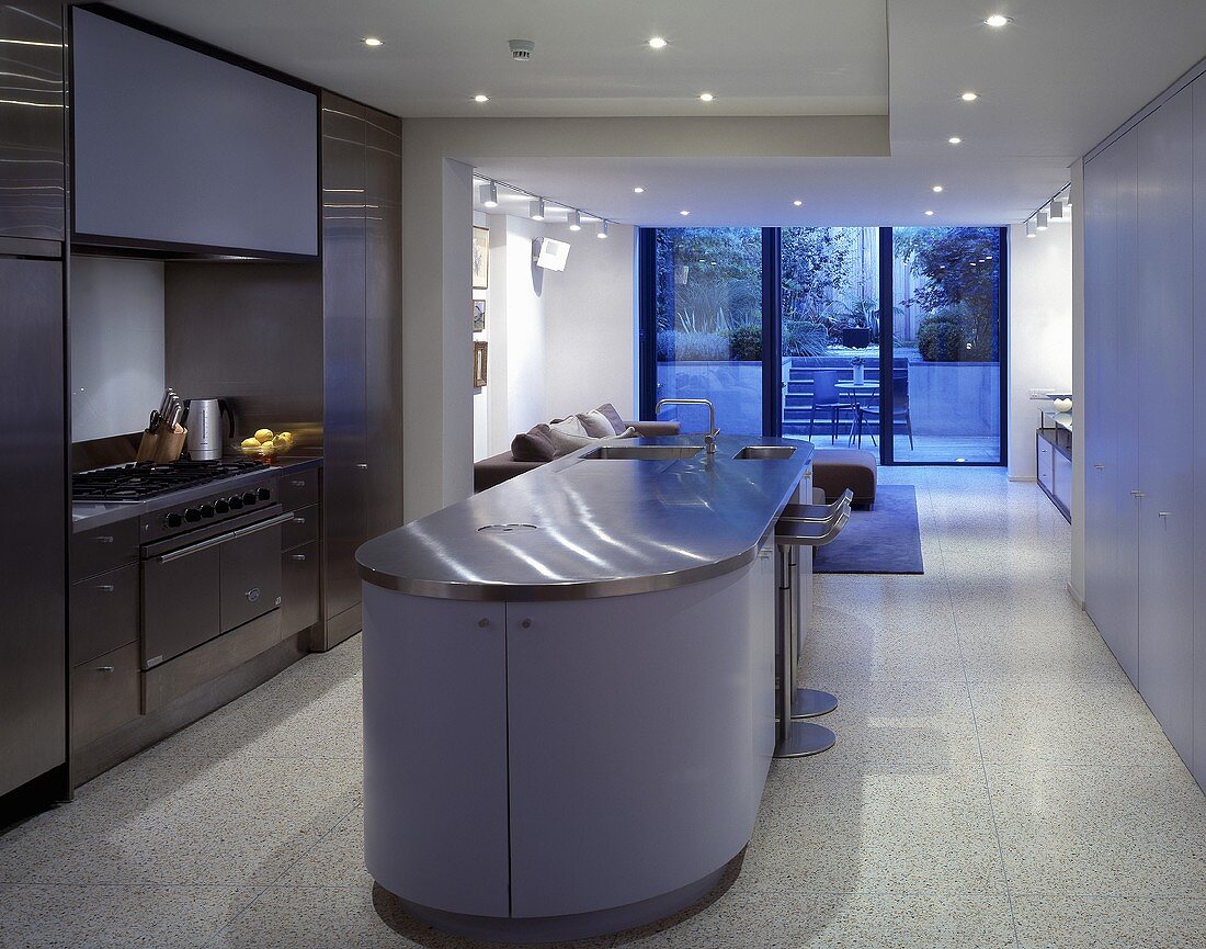 A kitchen counter with a purple front in an open-plan kitchen and living room