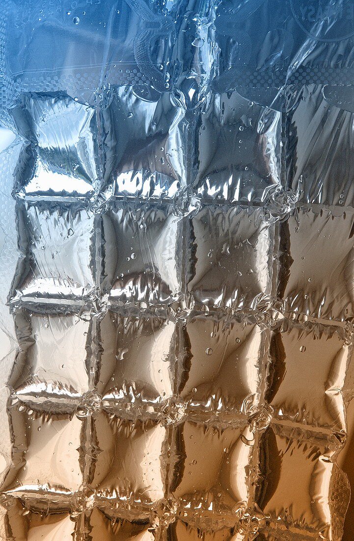 Coloured light shining through an ice cube bag