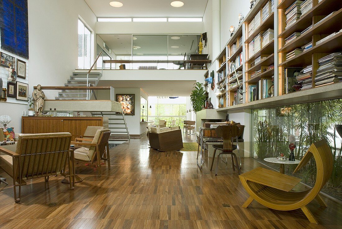 An open-plan living room with parquet flooring and chairs in a mixture of styles in a newly built house