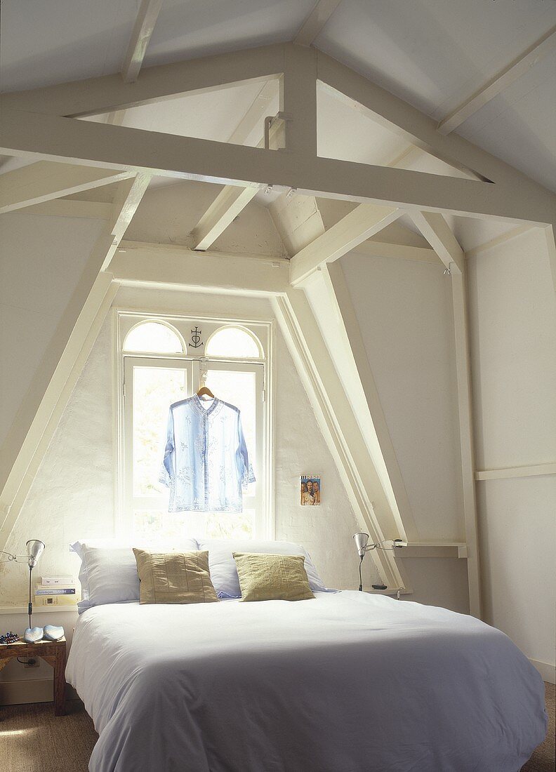 An attic bedroom with a double bed