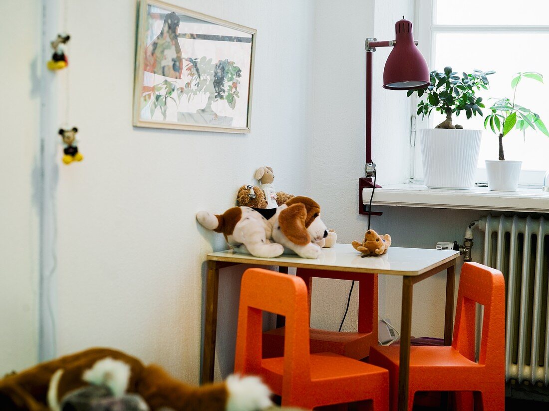 A table and small chairs in a child's room
