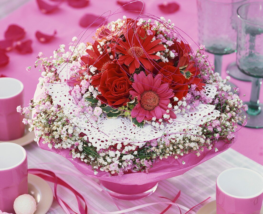 Romantic arrangement of roses, gerbera, gypsophila