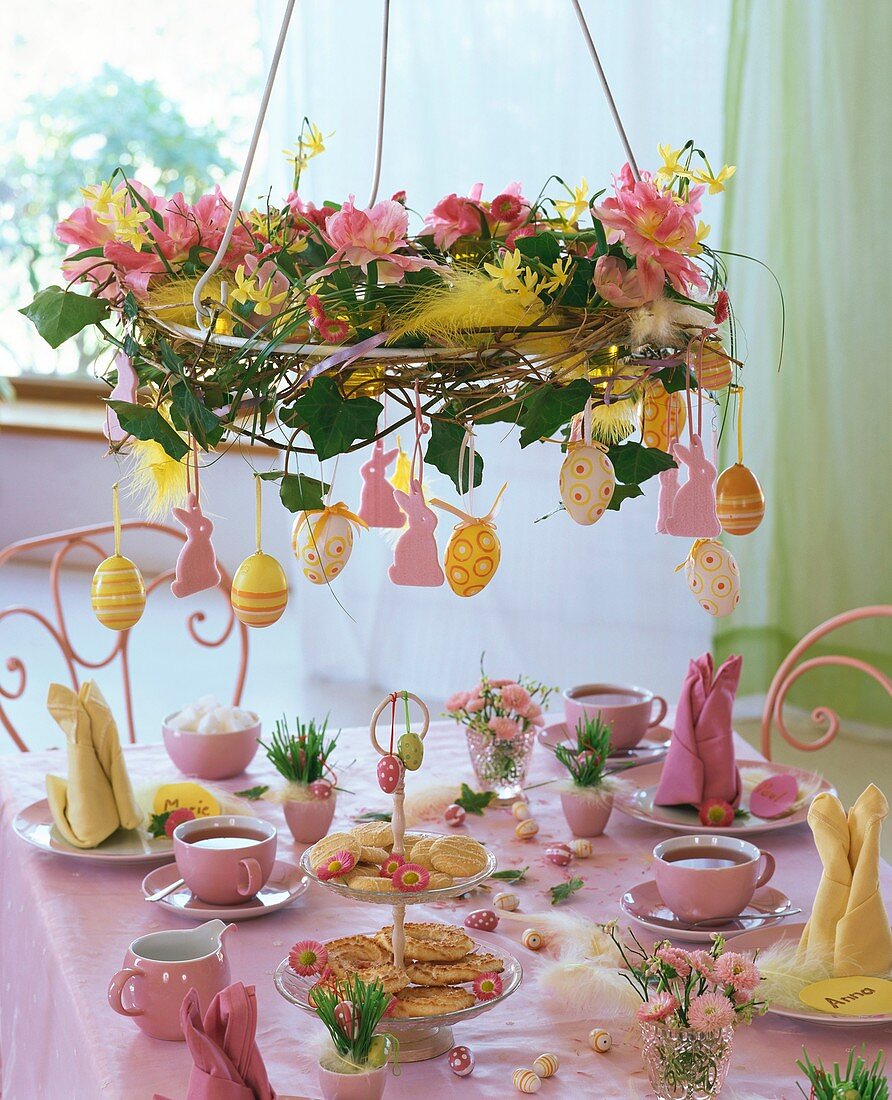 Wreath of tulips and narcissi hanging over Easter table
