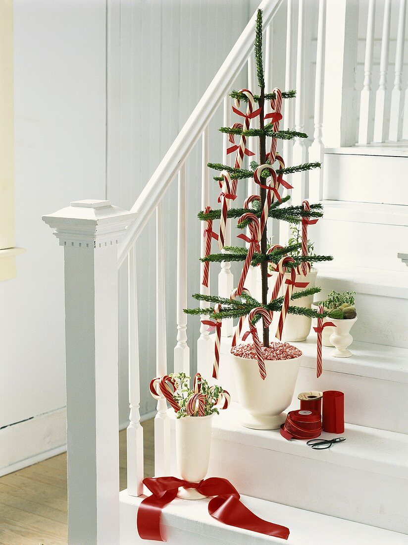 Artifical Christmas tree with candy canes on staircase