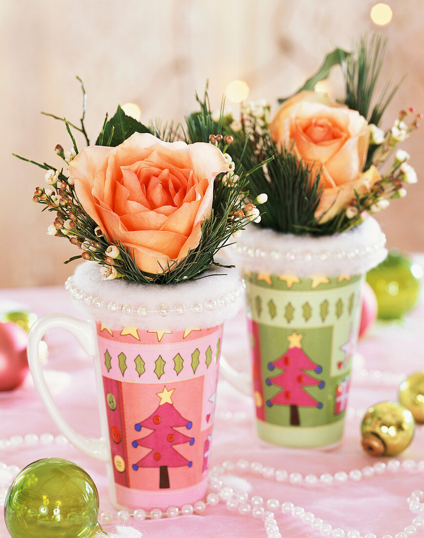 Roses with white pine in coloured beakers with fir motif