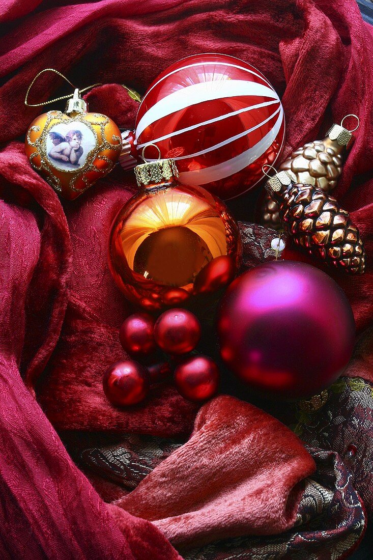 Christmas baubles on red cloth