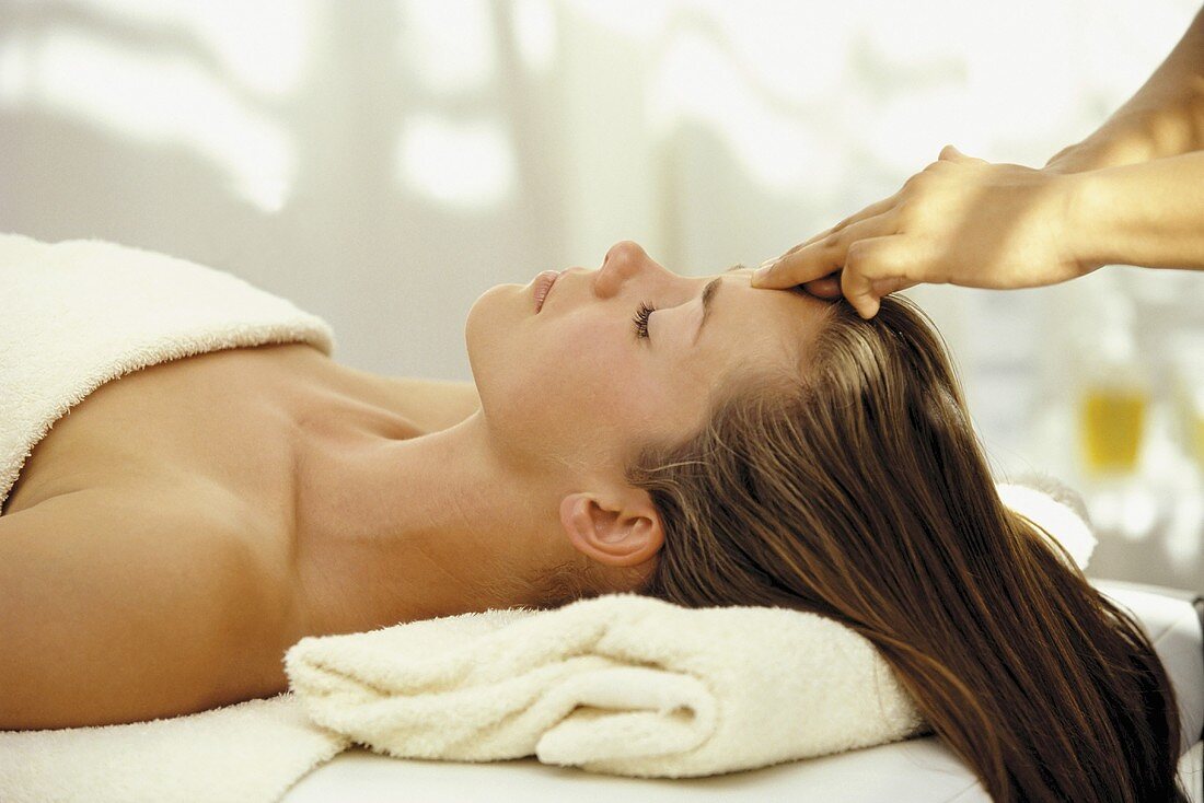 A woman having head massage