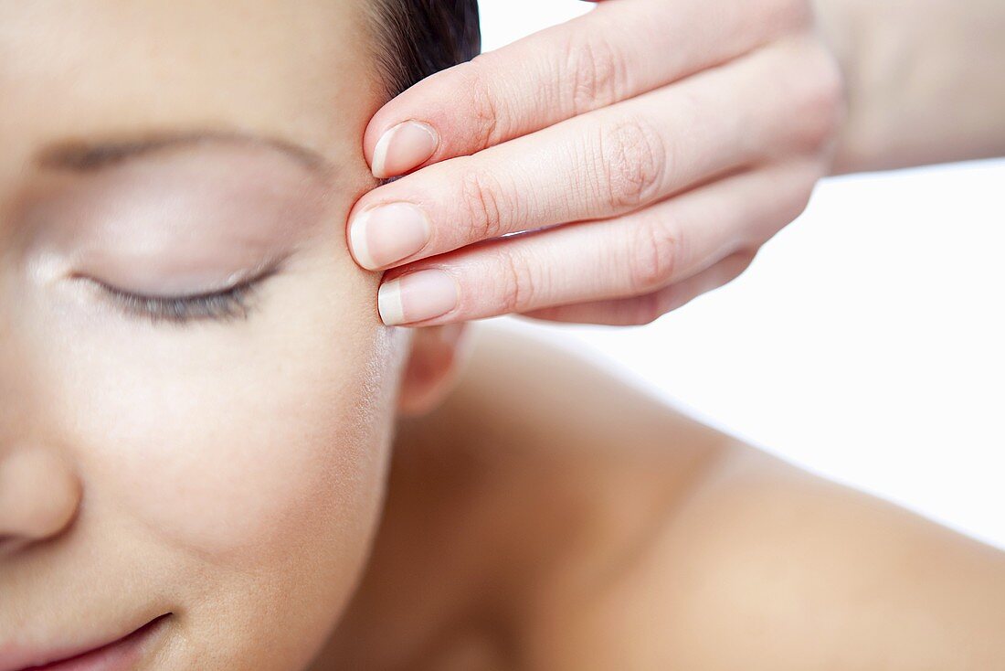 A woman having a face massage