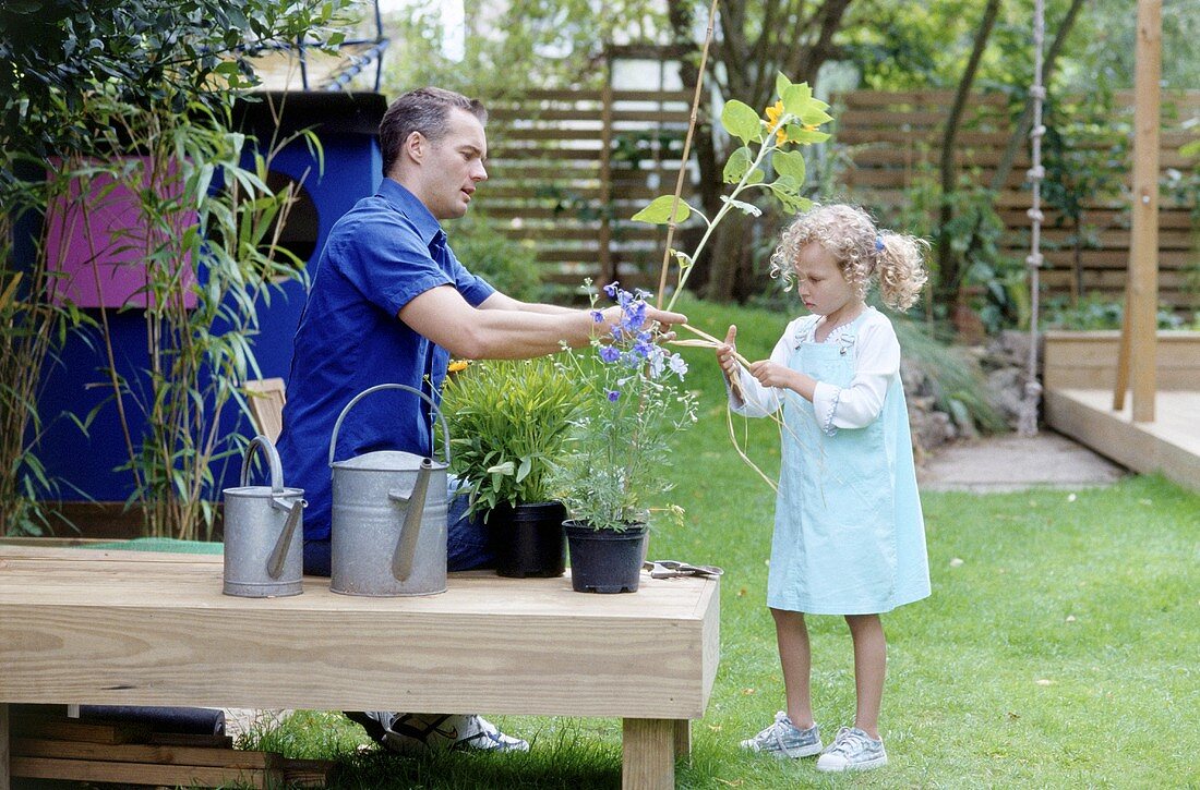 A father and daughter working in a garden