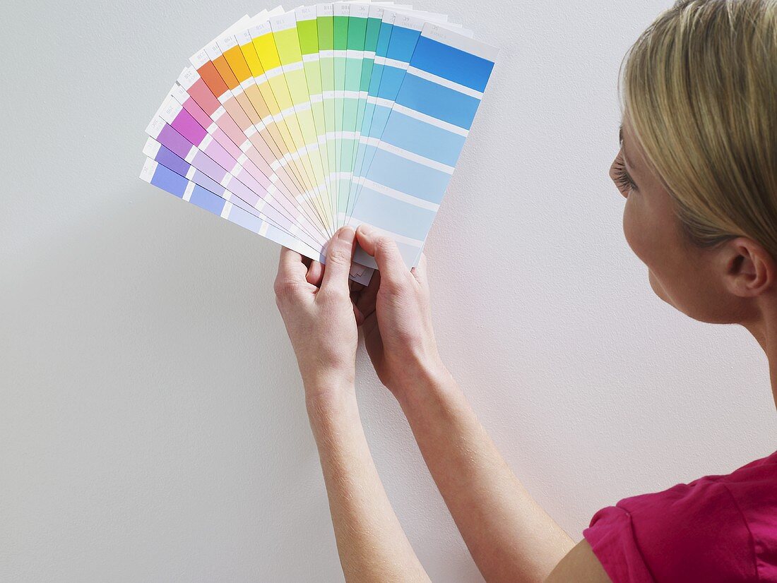 A woman looking at colour charts