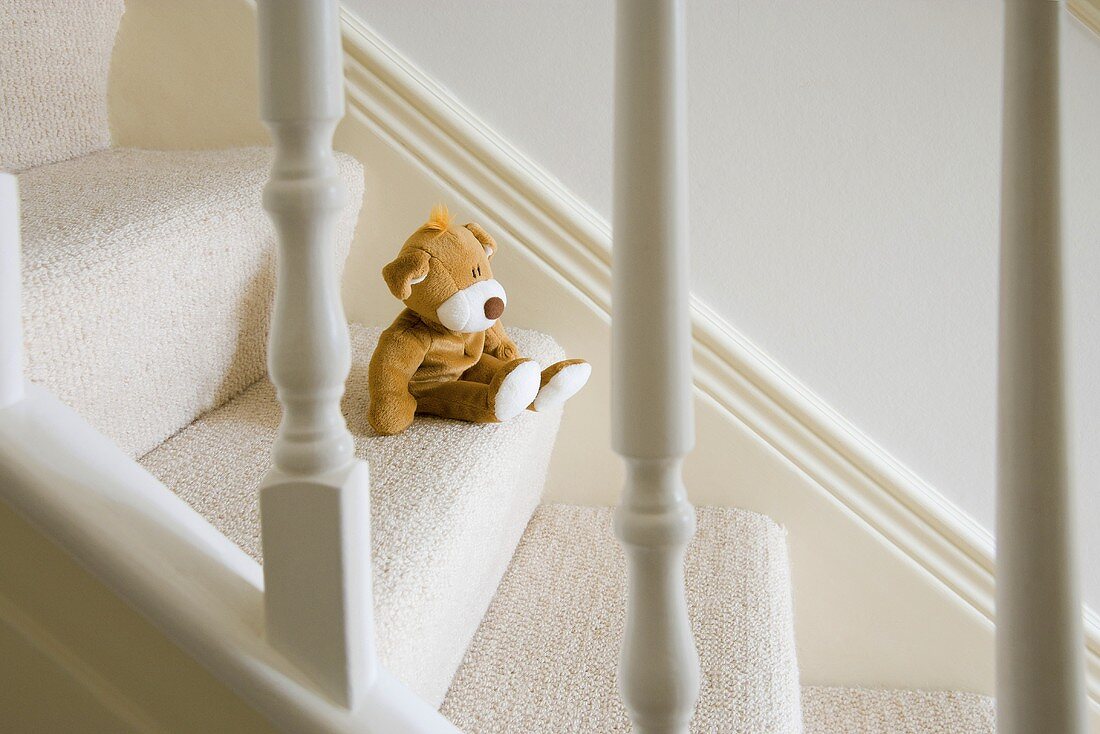 A soft toy on the stairs