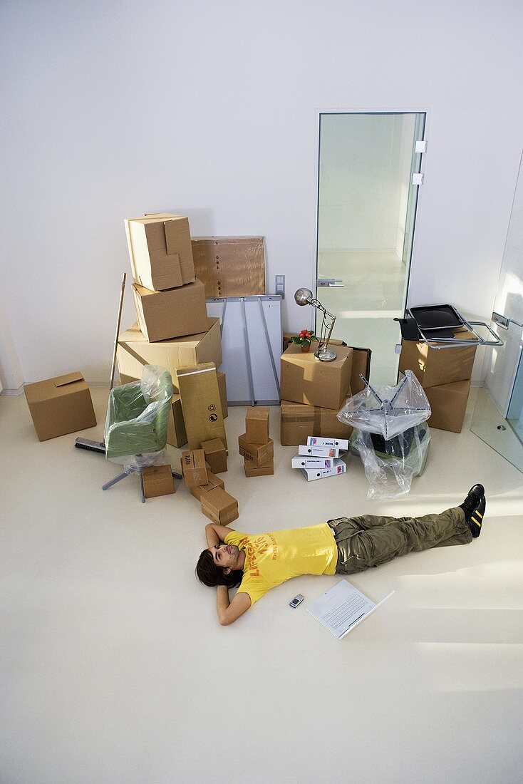 A man lying on the floor of a new office