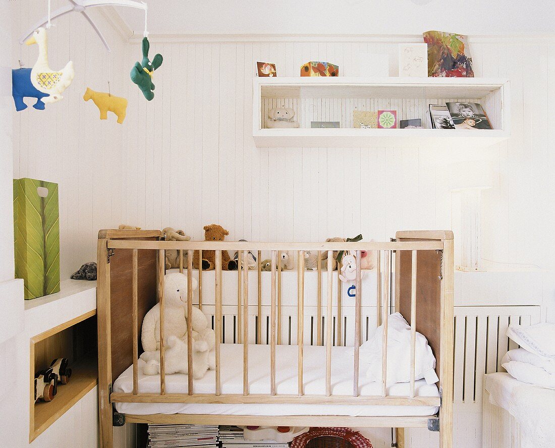 A baby's bedroom with teddy bears in the cot