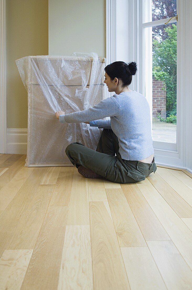 A woman unpacking a picture