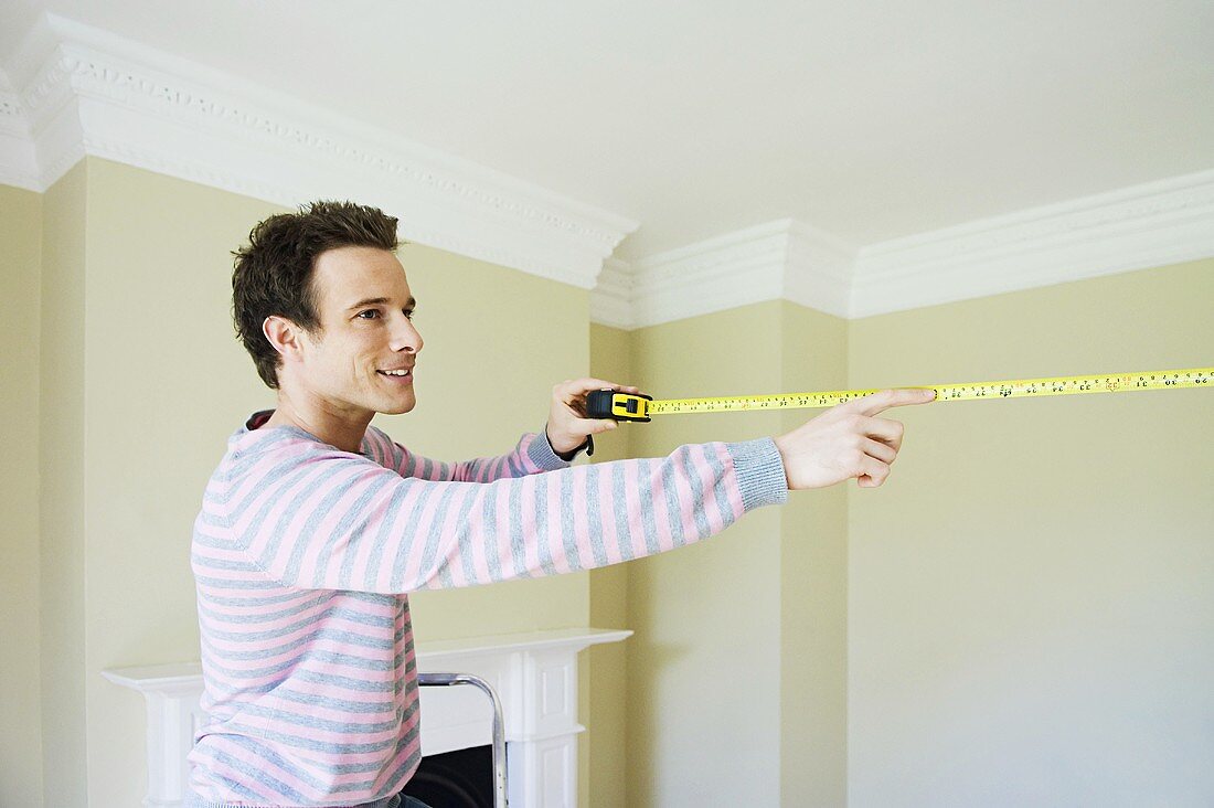 A man with a tape measure