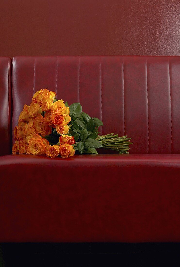 A bunch of roses left on a sofa