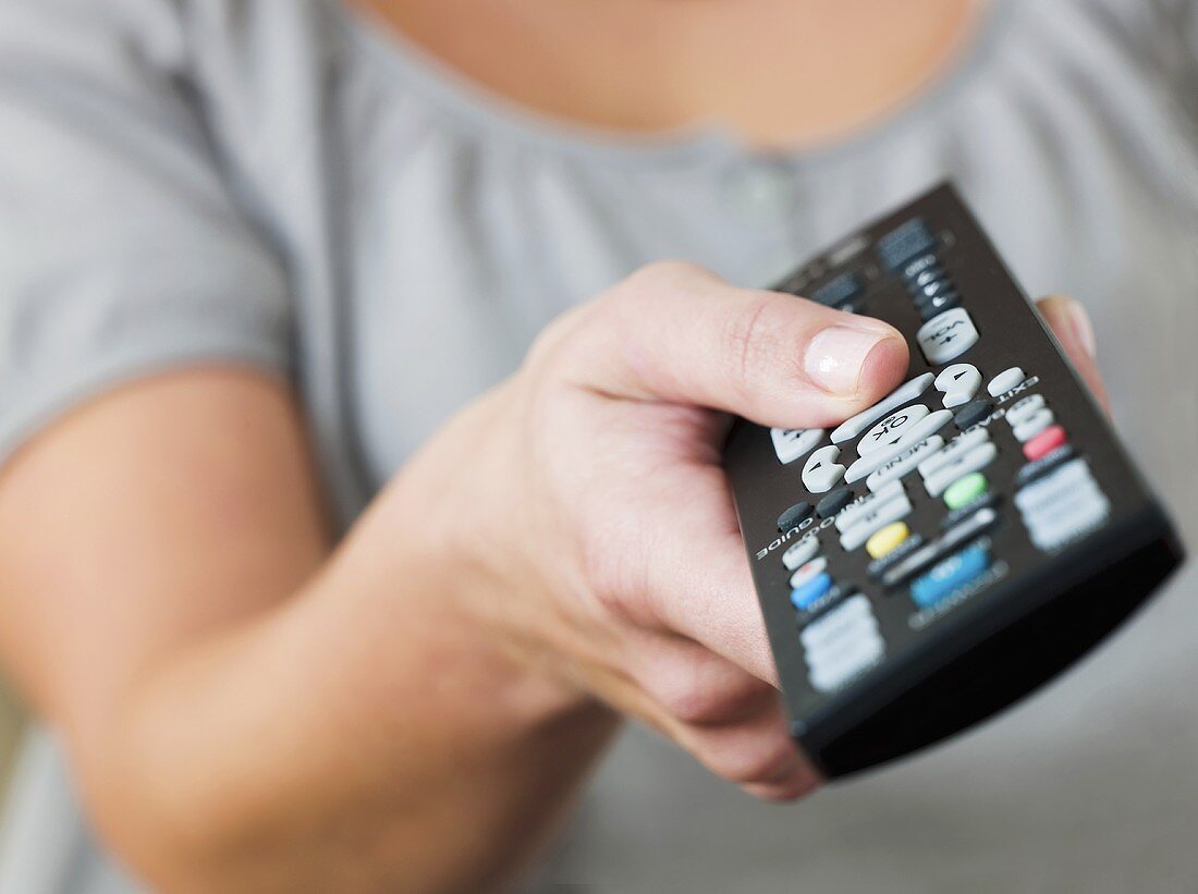 A woman holding a remote control