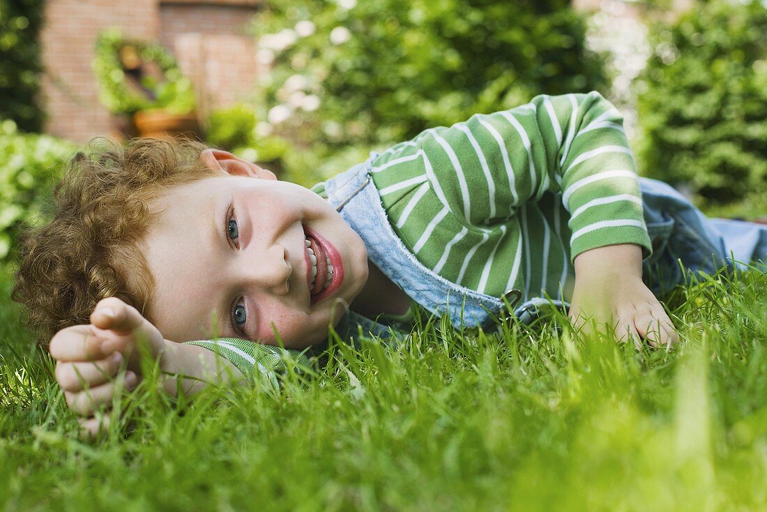 A picture of a boy lying on the grass