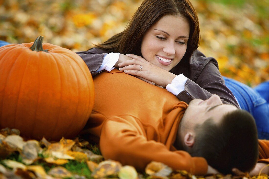 A young couple lying on leaves