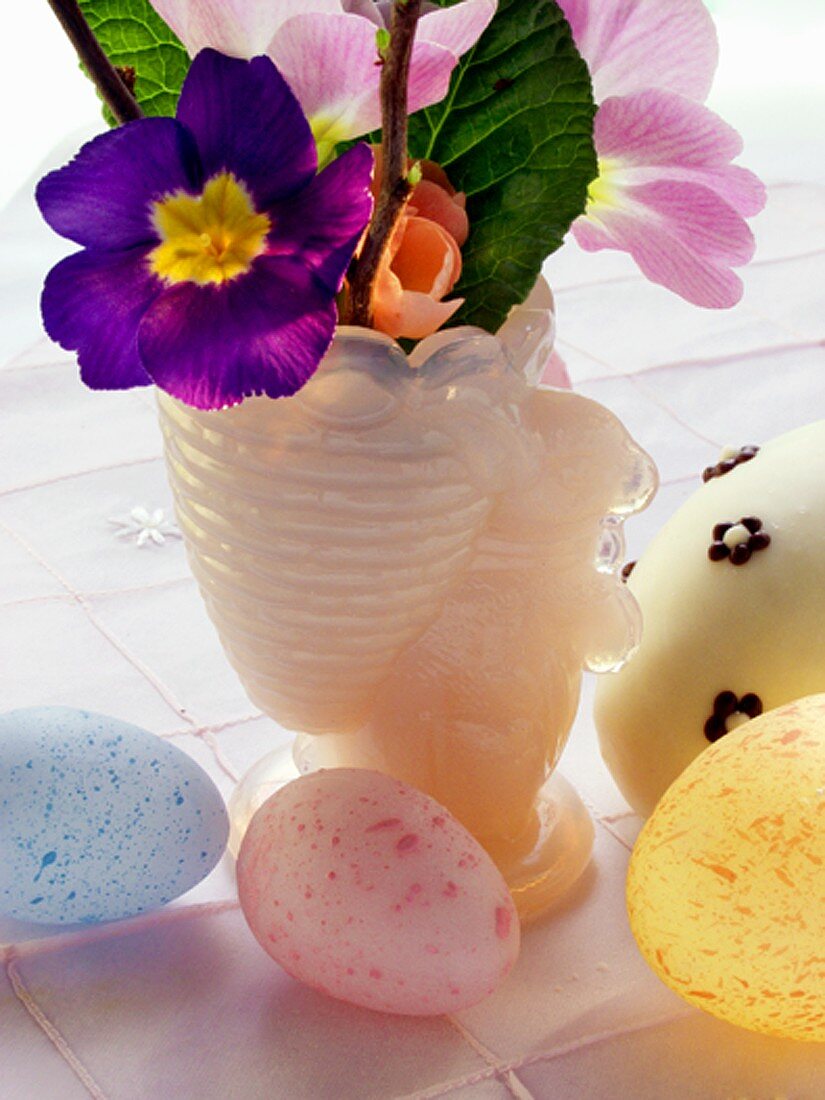 Pastel-coloured Easter eggs and spring flowers
