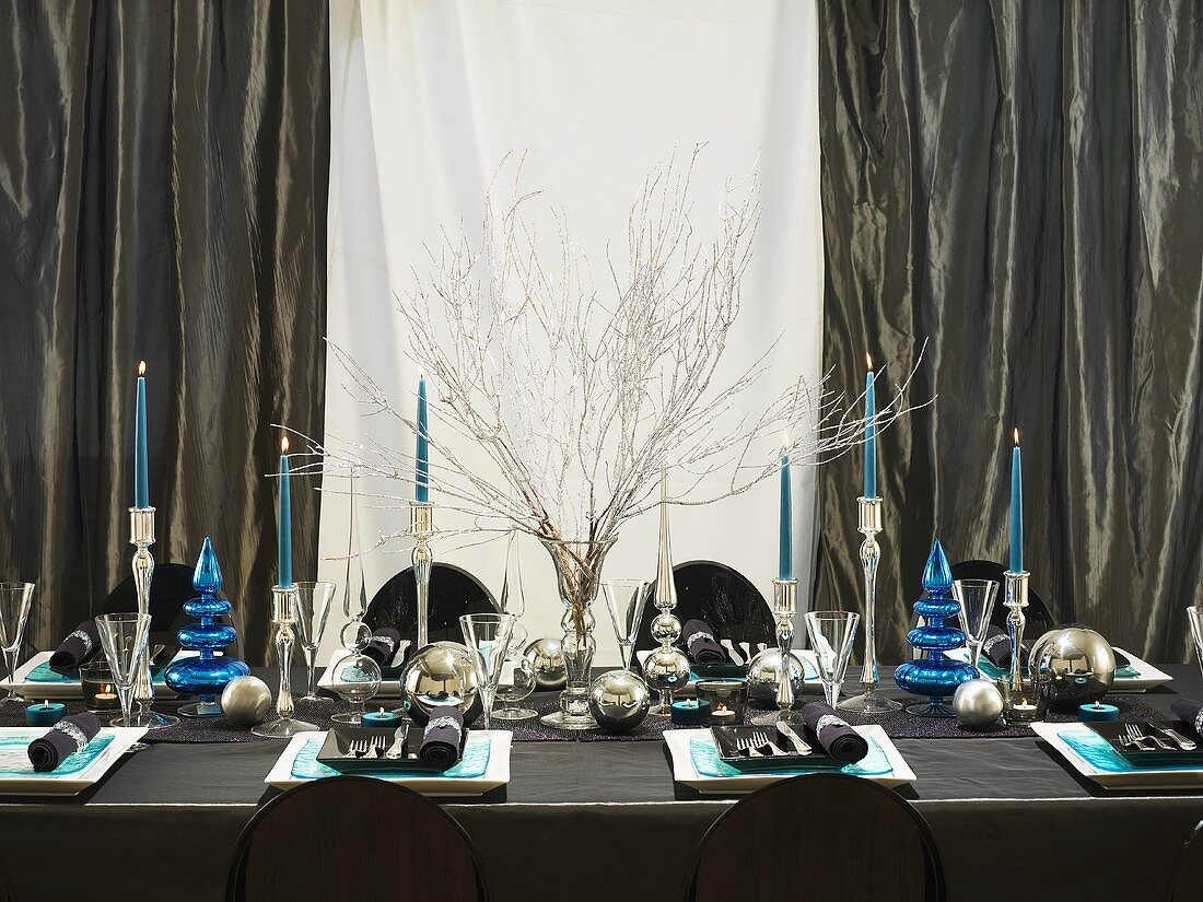 A festively laid Christmas table in blue and silver
