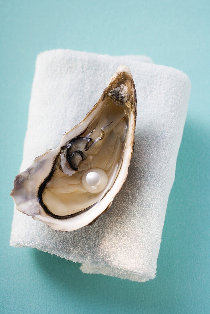 Fresh oyster with pearl on towel
